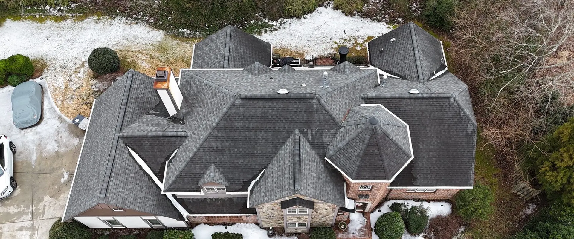Drone roof inspection photo of a large hip roof home in Greensboro, NC