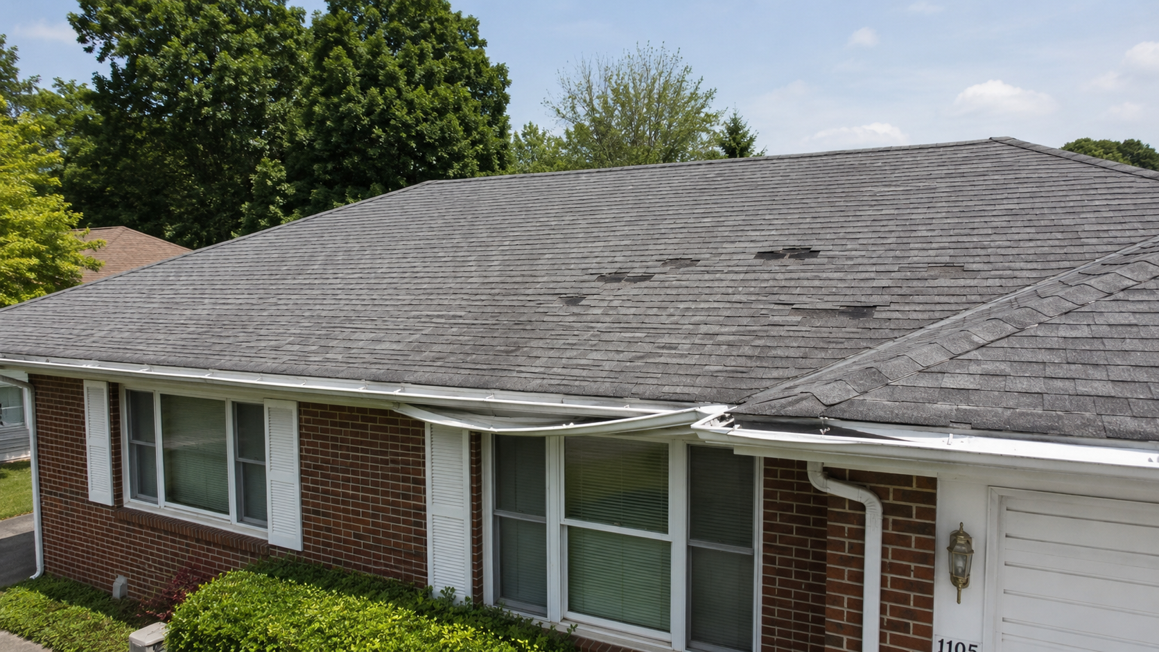 A damaged roof with missing shingles