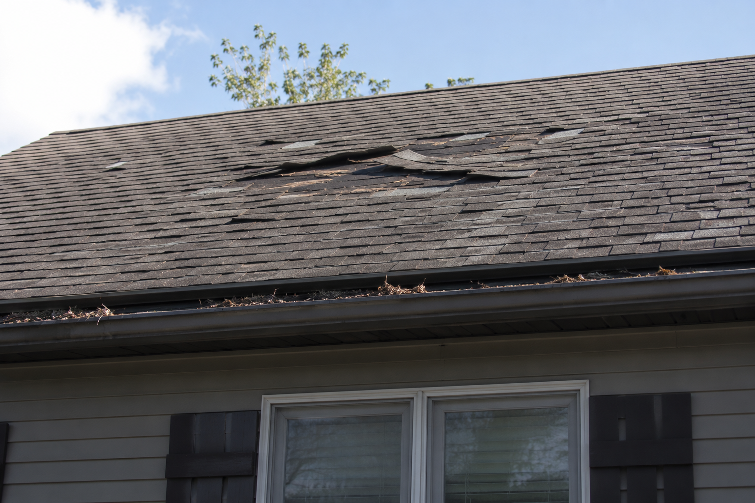 Missing shingles on a damaged roof