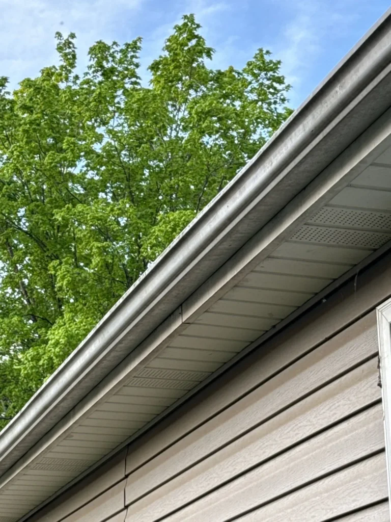 New white gutter along the roof edge of an Asheboro, NC home