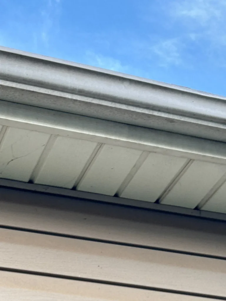 Close-up of a new white seamless gutter along the fascia in Asheboro, NC