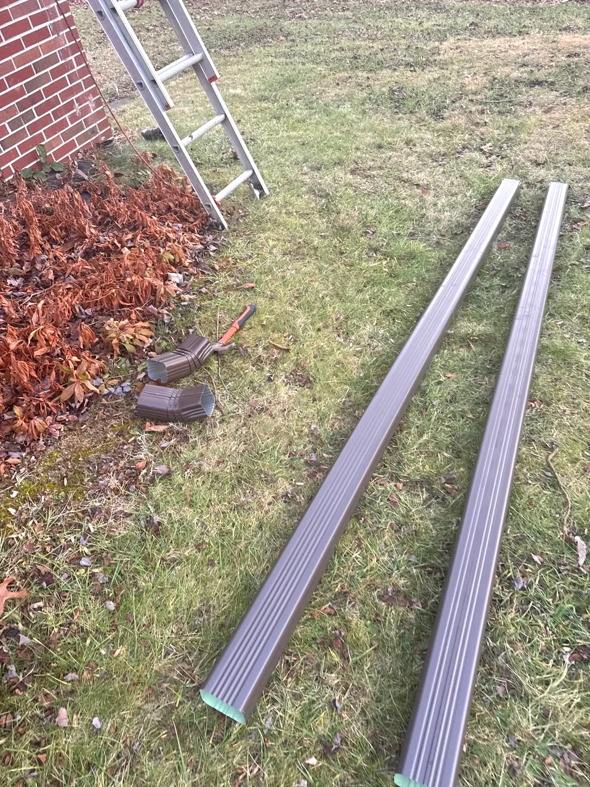 Brown seamless gutter sections custom-made for a home in Sparta, NC