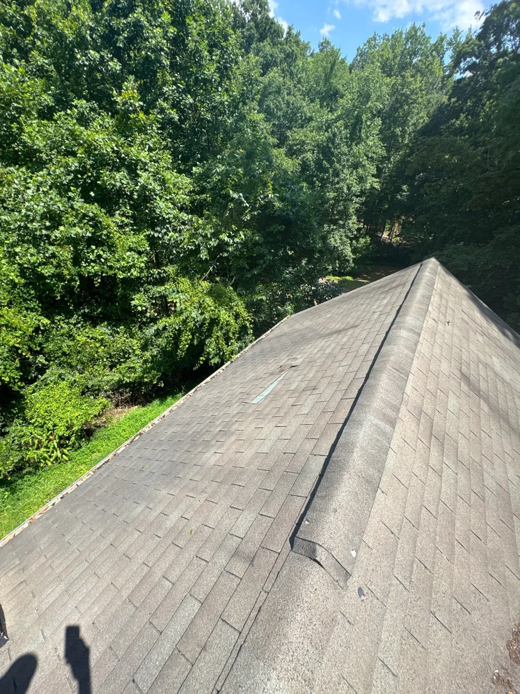 Shingle roof ridge photographed during a roof inspection in Clemmons, NC