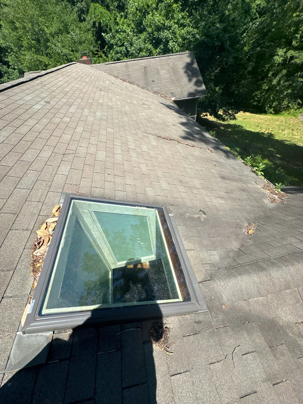 Skylight and shingles checked during a roof inspection in Clemmons, NC