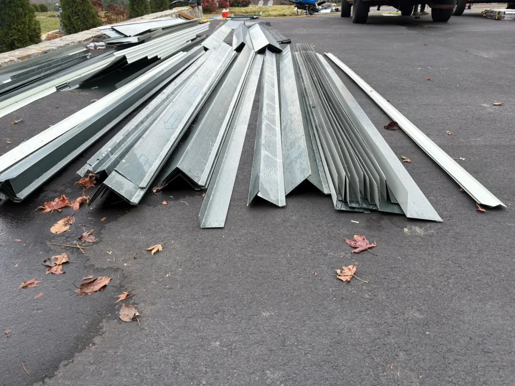 Hand-bent standing seam metal roof trim pieces ready for install in Sparta, NC