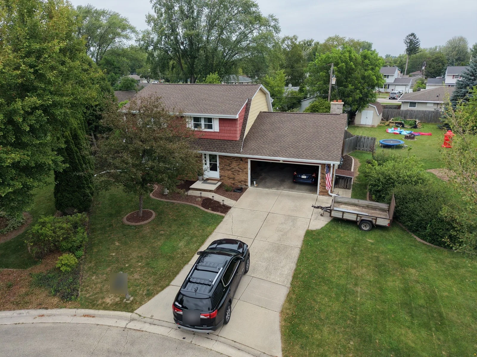 Front drone view of the Green Bay home after replacement with GAF Timberline HDZ shingles in Barkwood