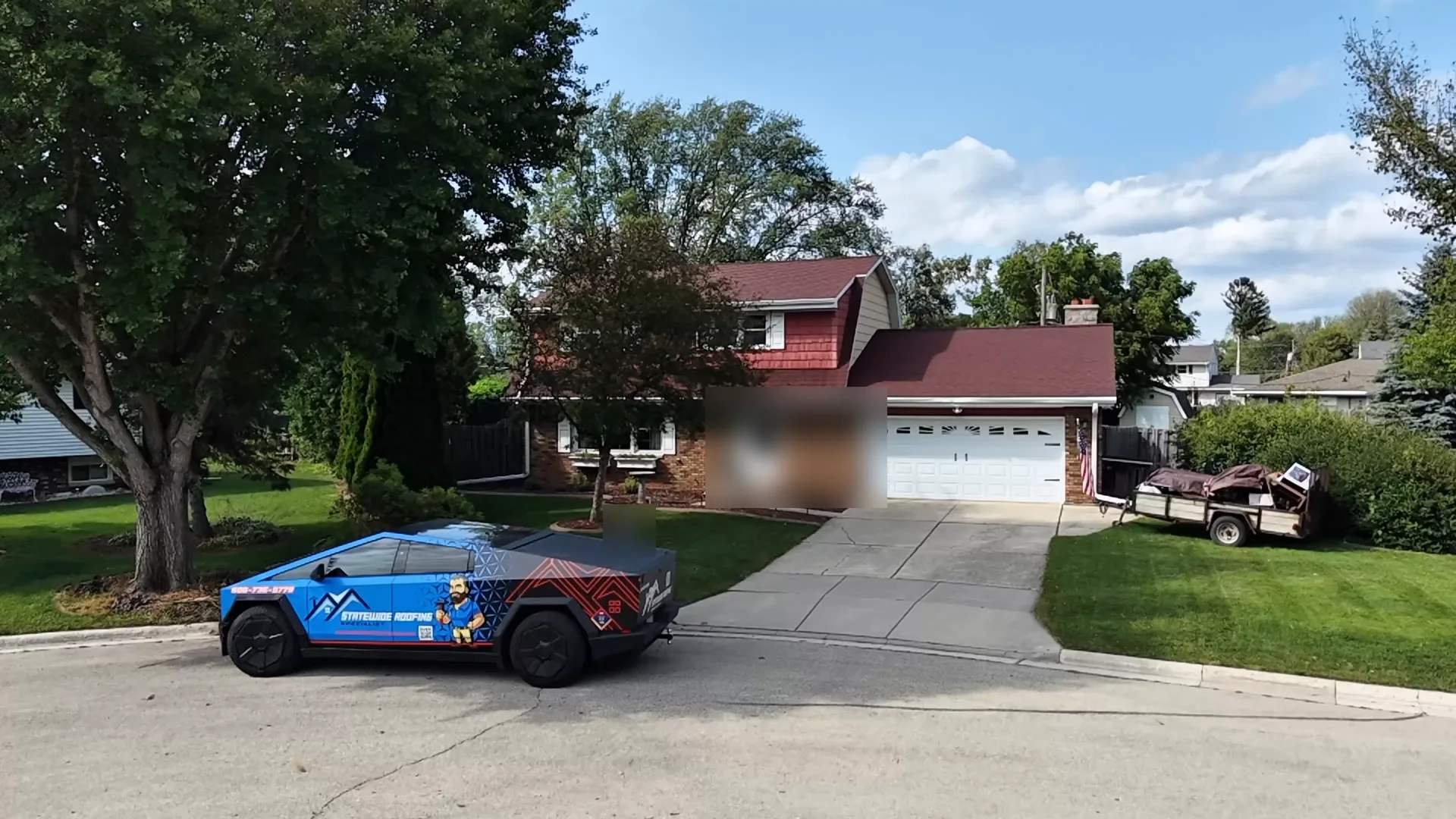 Front of a Green Bay home before roof replacement, worn red architectural shingles, Statewide Roofing truck at the curb