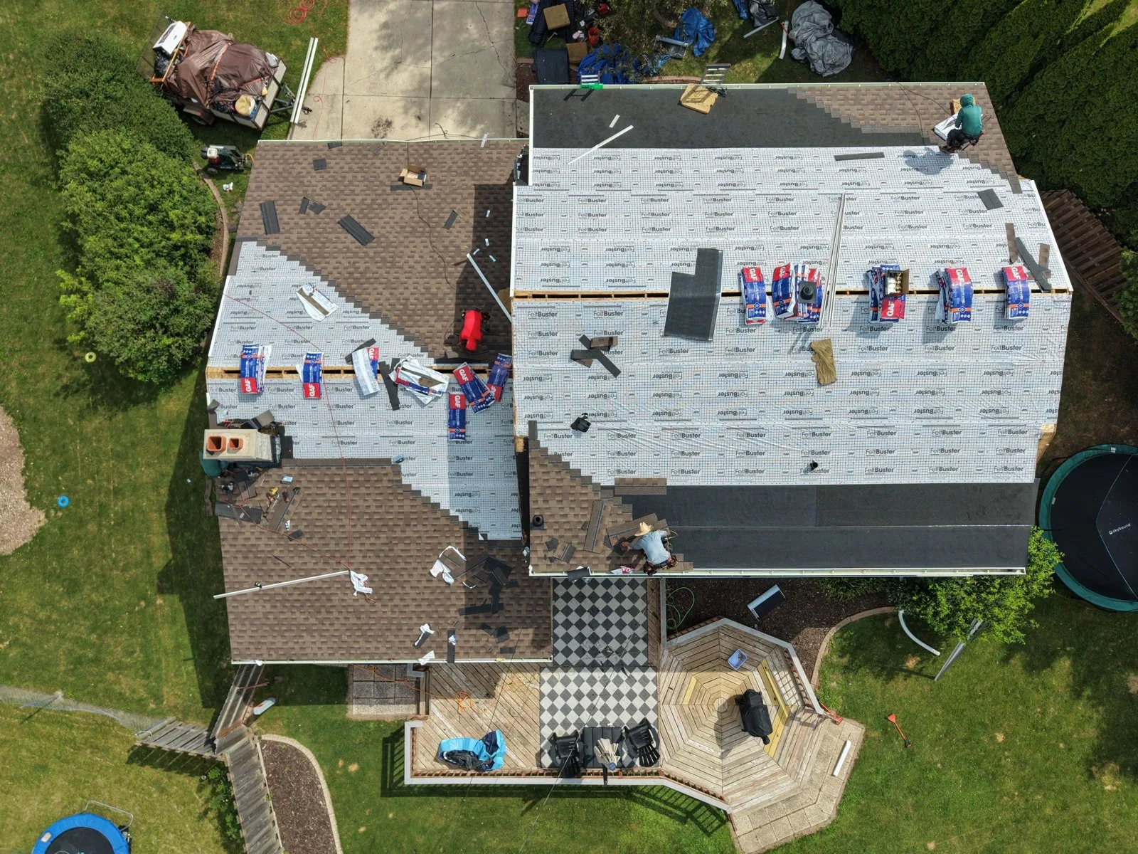 Overhead drone view of the crew installing synthetic underlayment during the Green Bay roof replacement