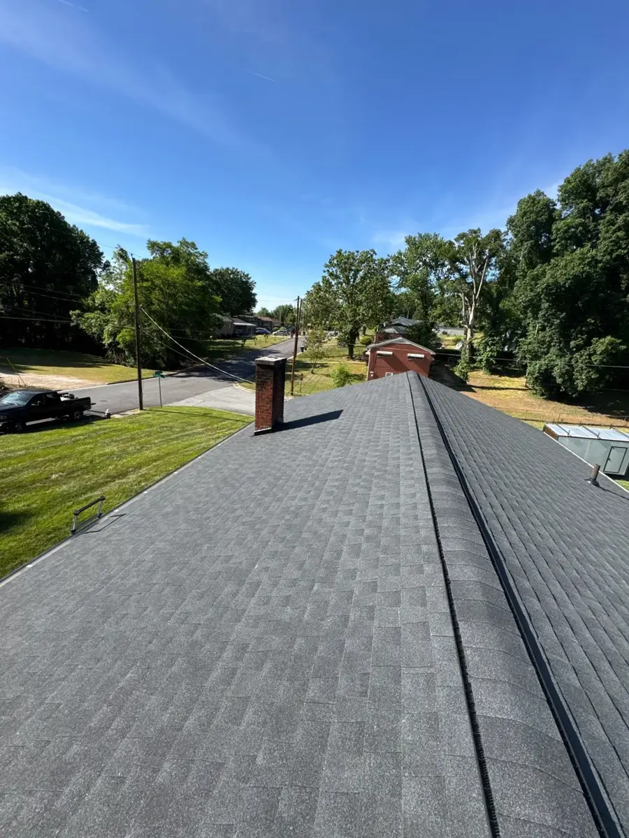 Ridge line of a newly replaced shingle roof in High Point, NC