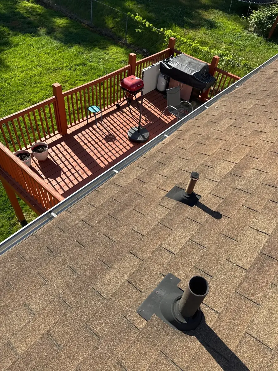 Close-up of old worn shingles and roof vents on a High Point, NC home before replacement