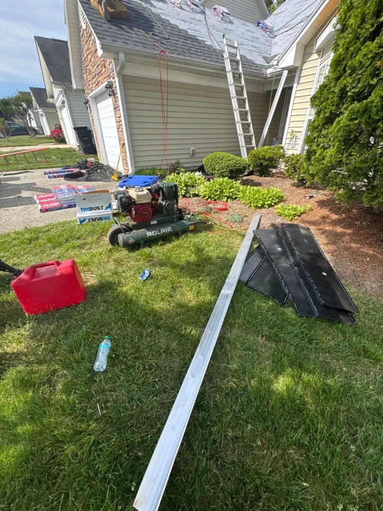 Long new seamless gutter run laid out on the lawn before install in High Point, NC