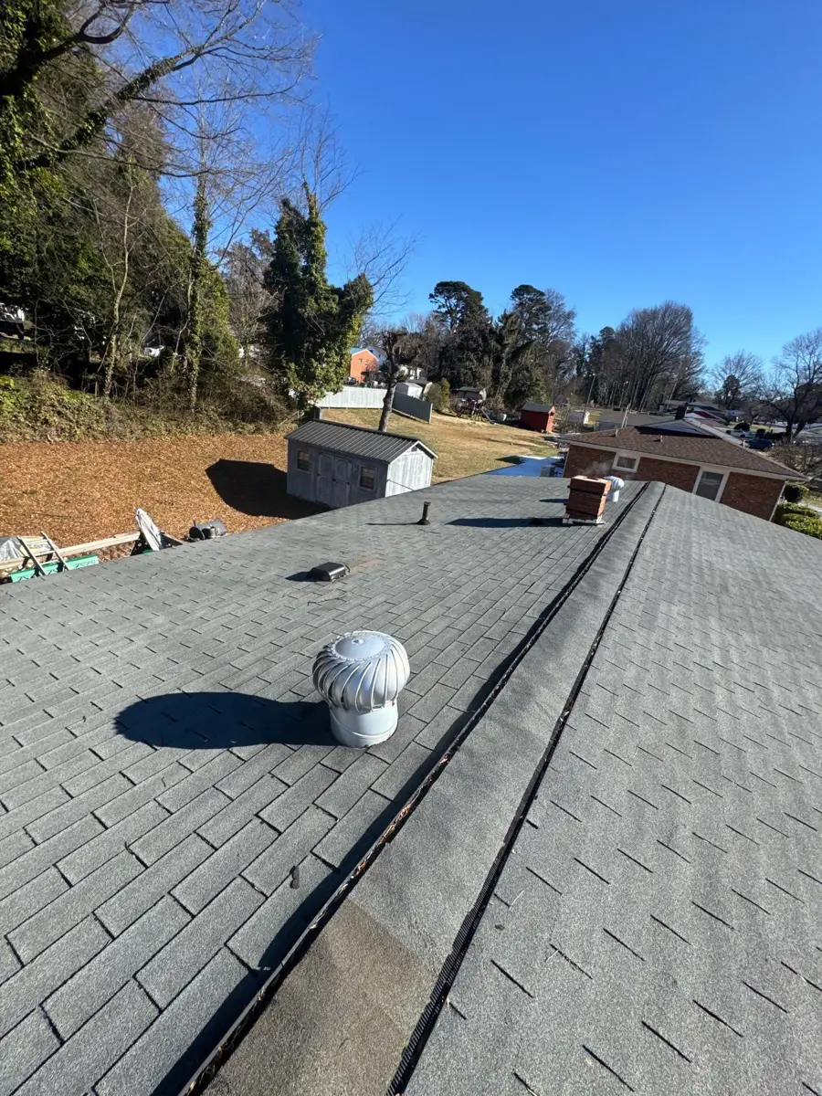 Worn shingle roof with a turbine vent on a High Point, NC home before replacement