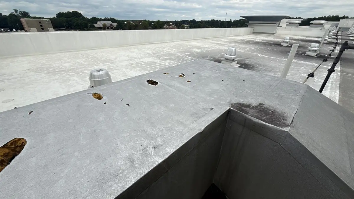 Commercial flat roof with rooftop units after roof work in Kernersville, NC