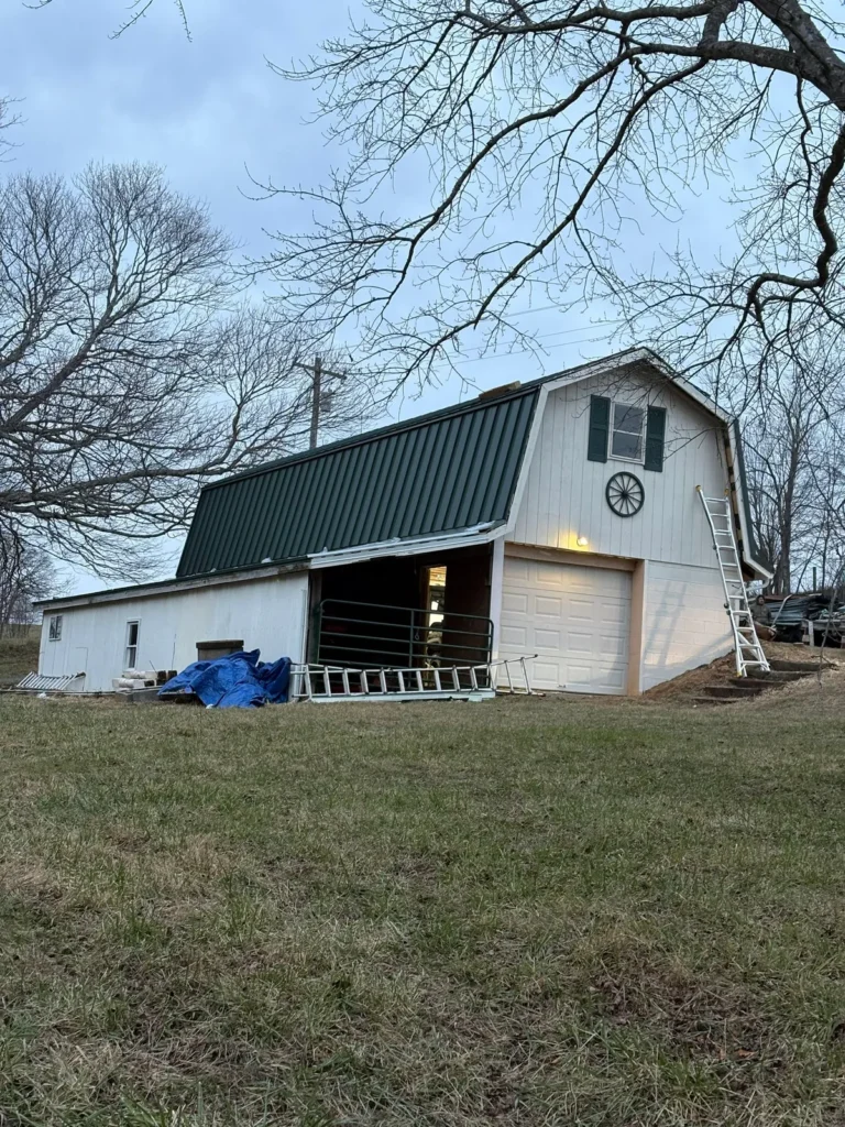 Gambrel barn in Sparta, NC with a new dark green standing seam metal roof