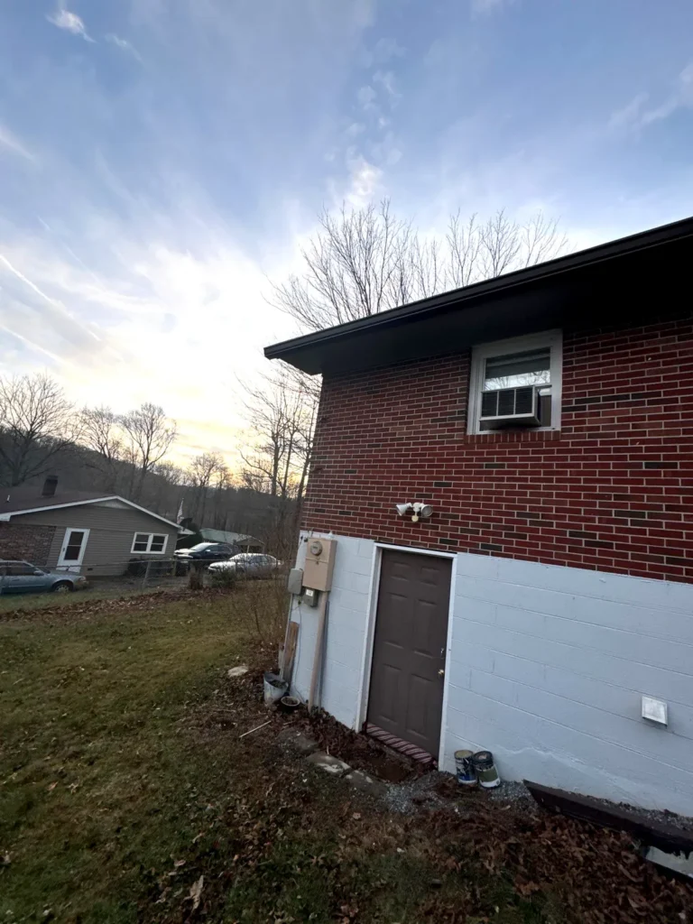 Brick home in Sparta, NC with new brown seamless gutters