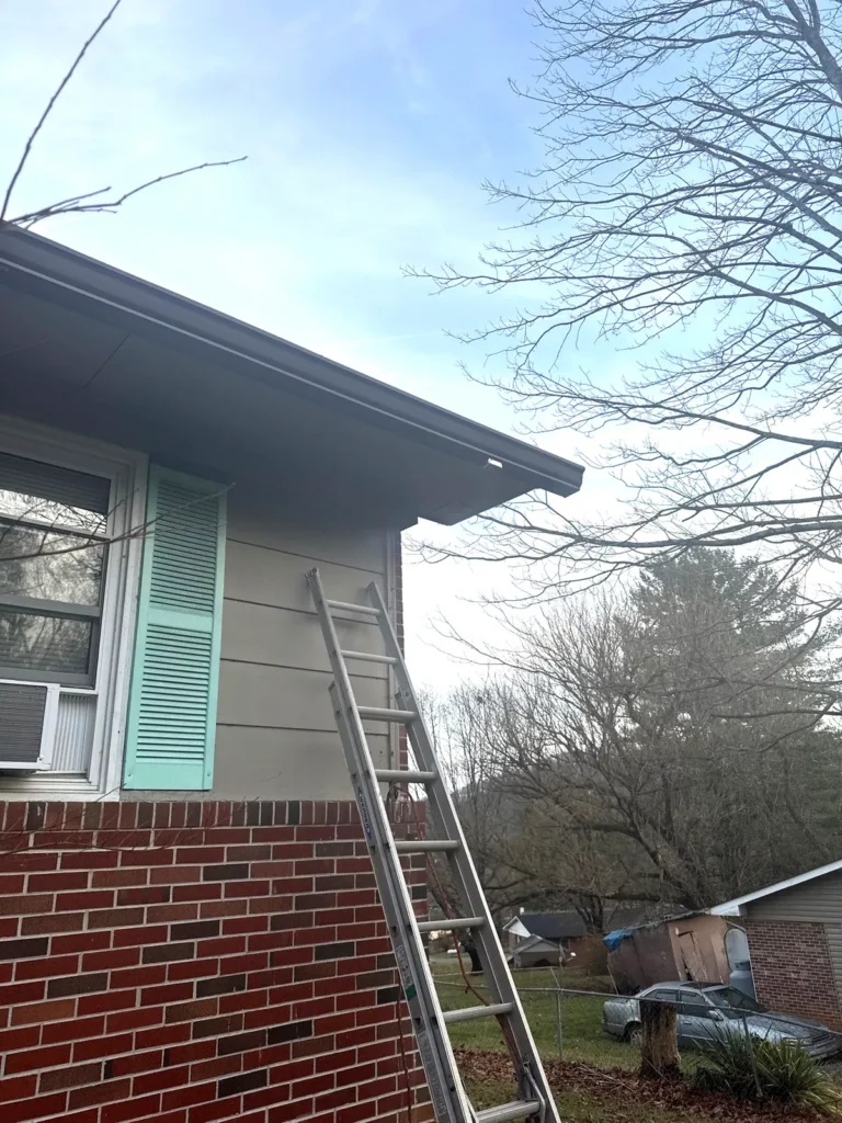 New brown seamless gutter installed along the eave of a Sparta, NC home