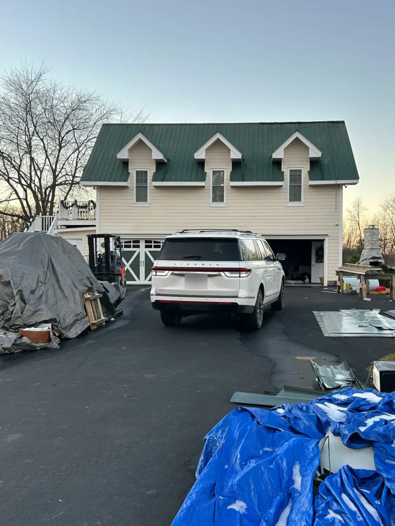 Carriage house in Sparta, NC with a new dark green standing seam metal roof