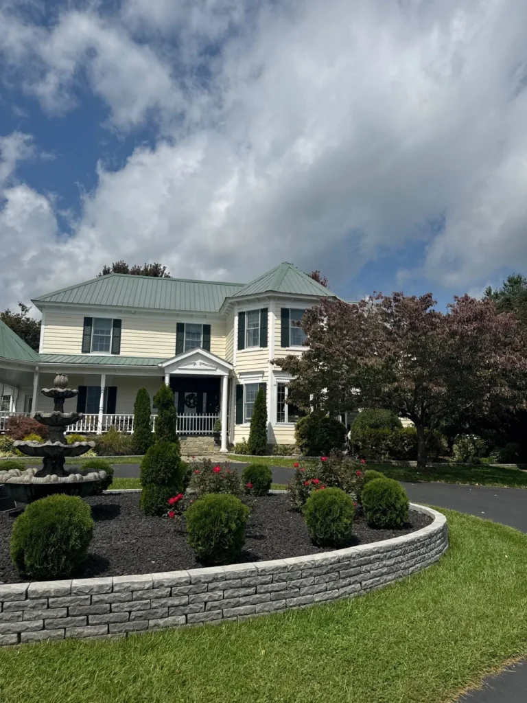 Main house in Sparta, NC with its old faded green ribbed metal roof before replacement