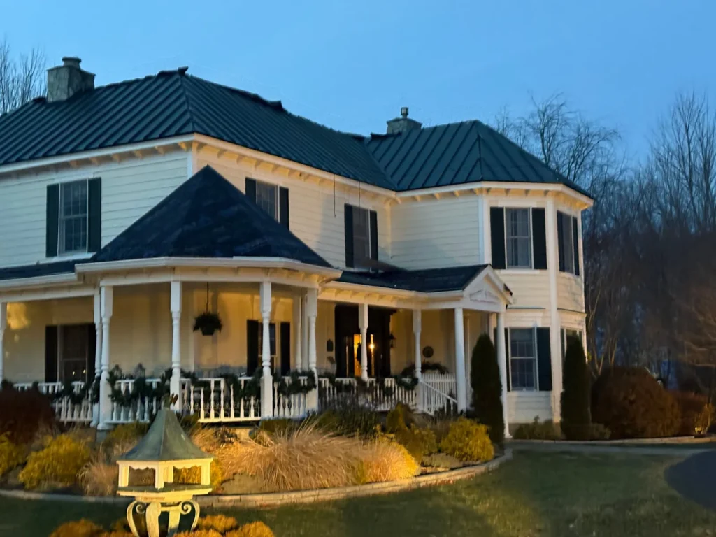 Two-story home in Sparta, NC with a new dark green standing seam metal roof