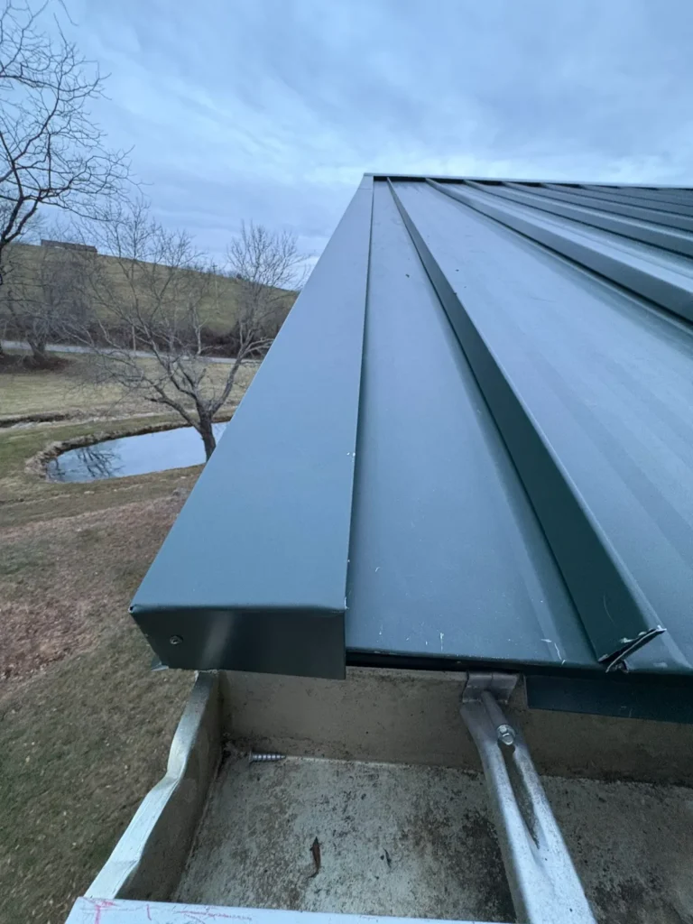 Close-up of dark green standing seam metal roof panels and seams