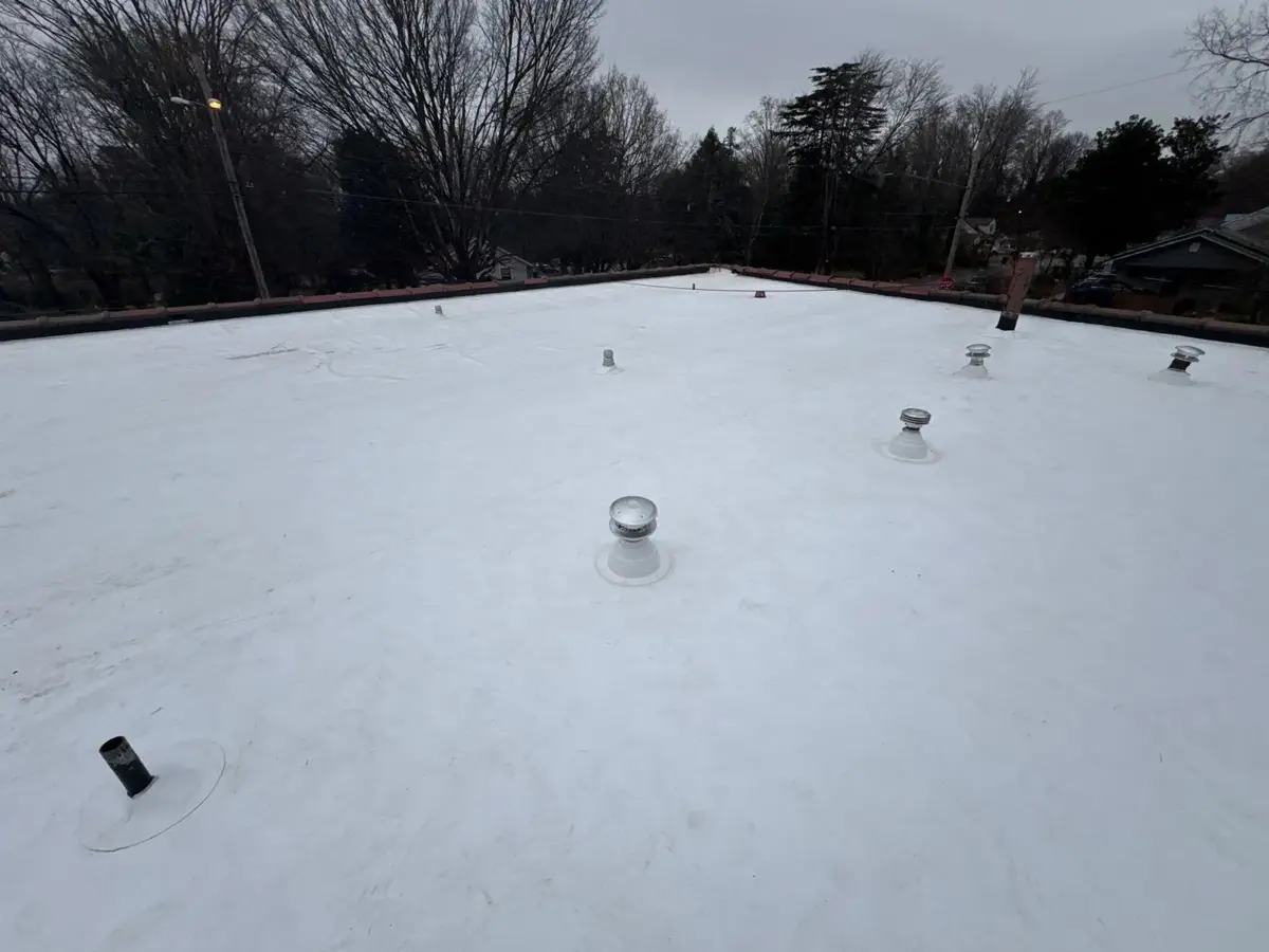 Finished white TPO church flat roof with new vent caps in Winston-Salem, NC